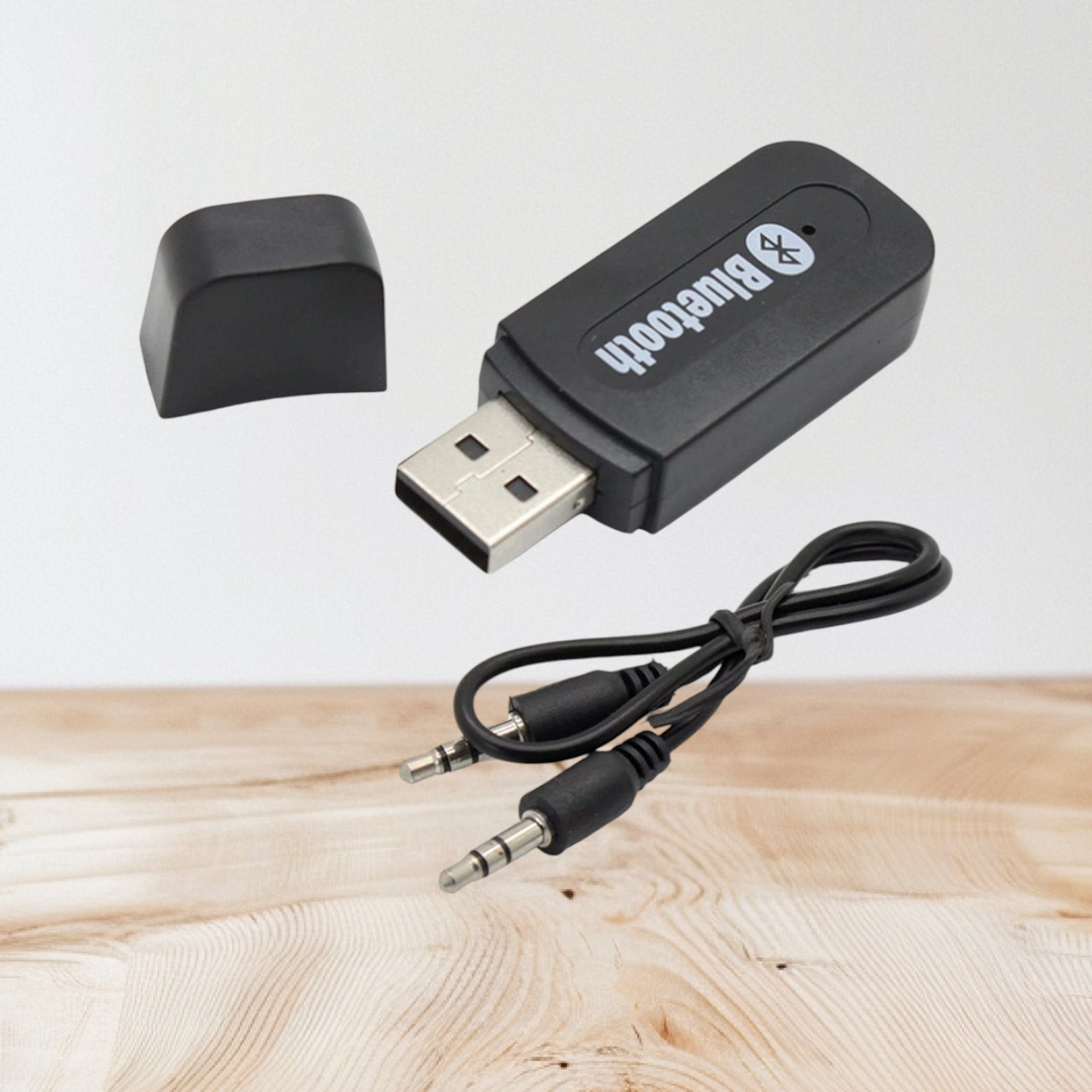 USB Bluetooth music receiver with an accompanying 3.5mm audio cable